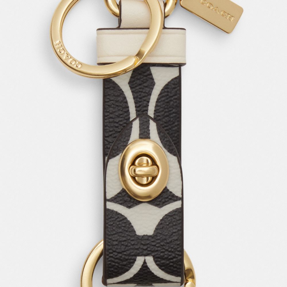 COACH®,TRIGGER SNAP BAG CHARM IN SIGNATURE CANVAS,Gold/Black Multi