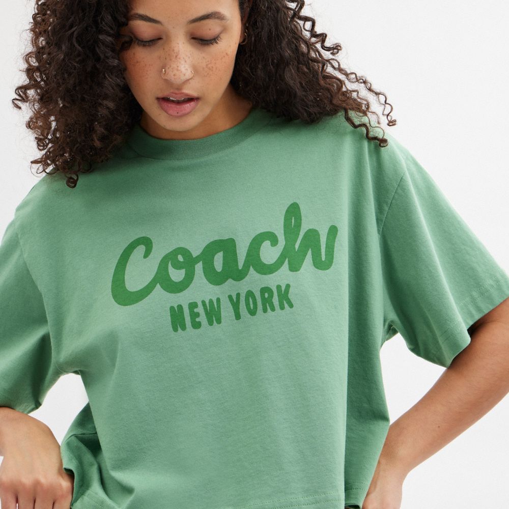 公式】COACH – コーチ | カーシヴ シグネチャー クロップド Tシャツ 
