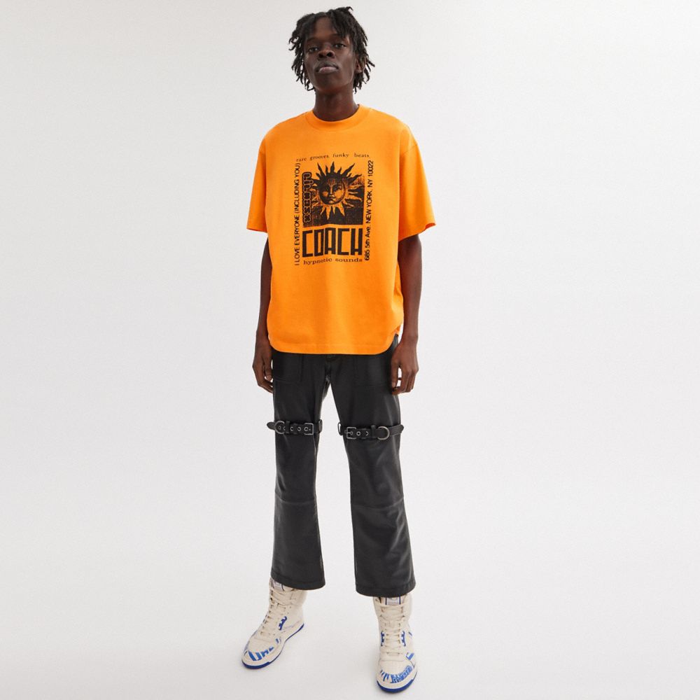 COACH®,【LIL NAS X DROP BY COACH】サン Tシャツ,トップス＆ボトムス,ｵﾚﾝｼﾞ