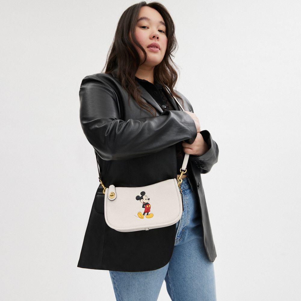 Coach Disney X  Swinger Bag In Regenerative Leather With Mickey Mouse In Brass/chalk Multi
