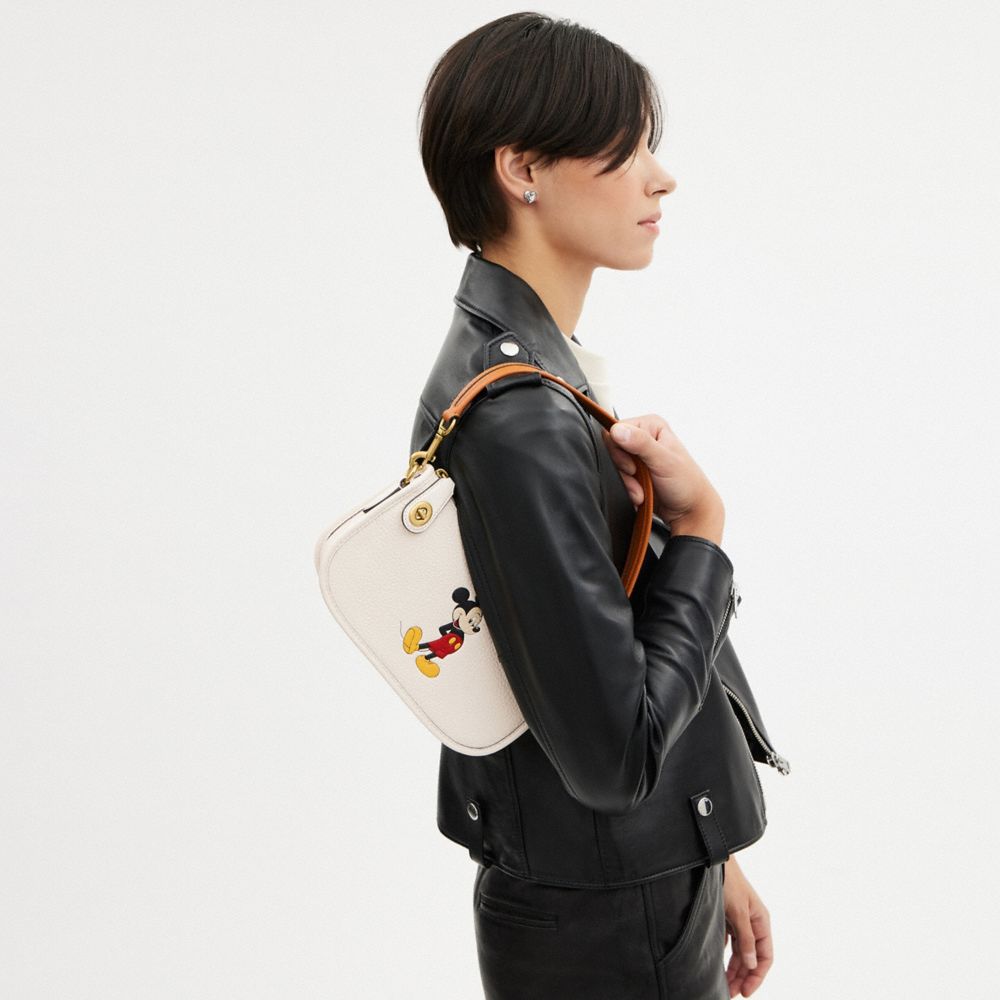 Coach Disney X  Swinger Bag In Regenerative Leather With Mickey Mouse In Brass/chalk Multi