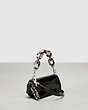 COACH®,Mini Wavy Dinky Bag with Crossbody Strap in Crinkled Patent Leather,Coachtopia Leather,Mini,Black,Angle View