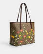COACH®,CITY TOTE BAG IN SIGNATURE CANVAS WITH FLORAL PRINT,pvc,X-Large,Gold/Khaki Multi,Angle View
