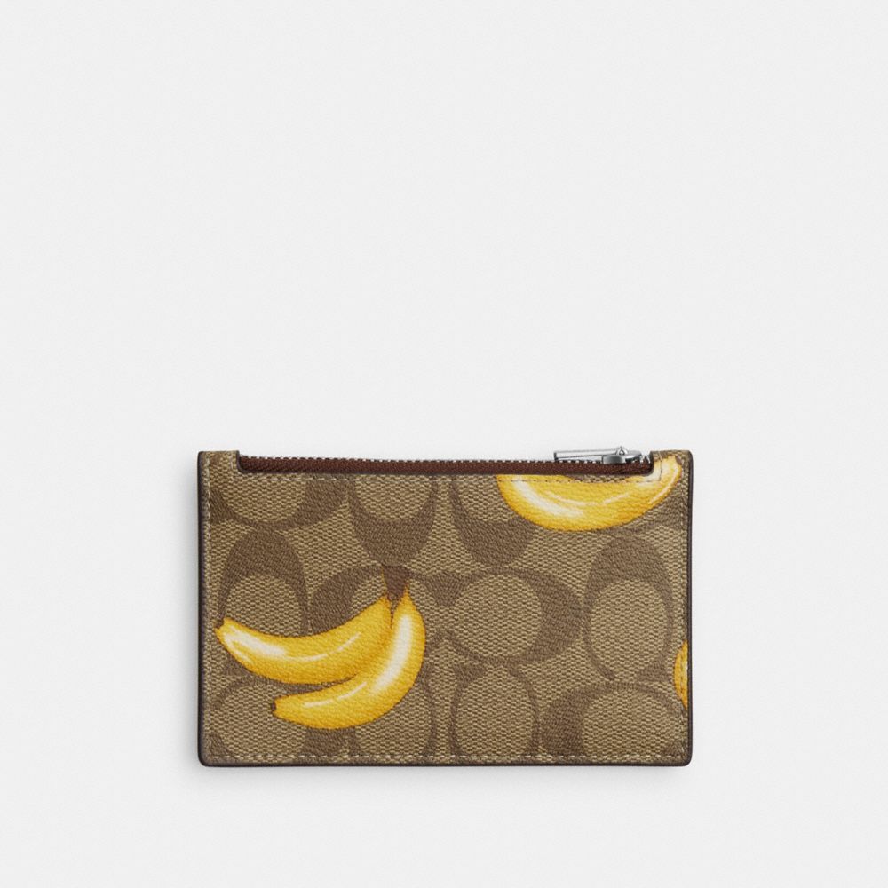 COACH®,ZIP CARD CASE IN SIGNATURE CANVAS WITH BANANA PRINT,Signature Canvas,Mini,Silver/Khaki/Dark Saddle,Front View image number 0