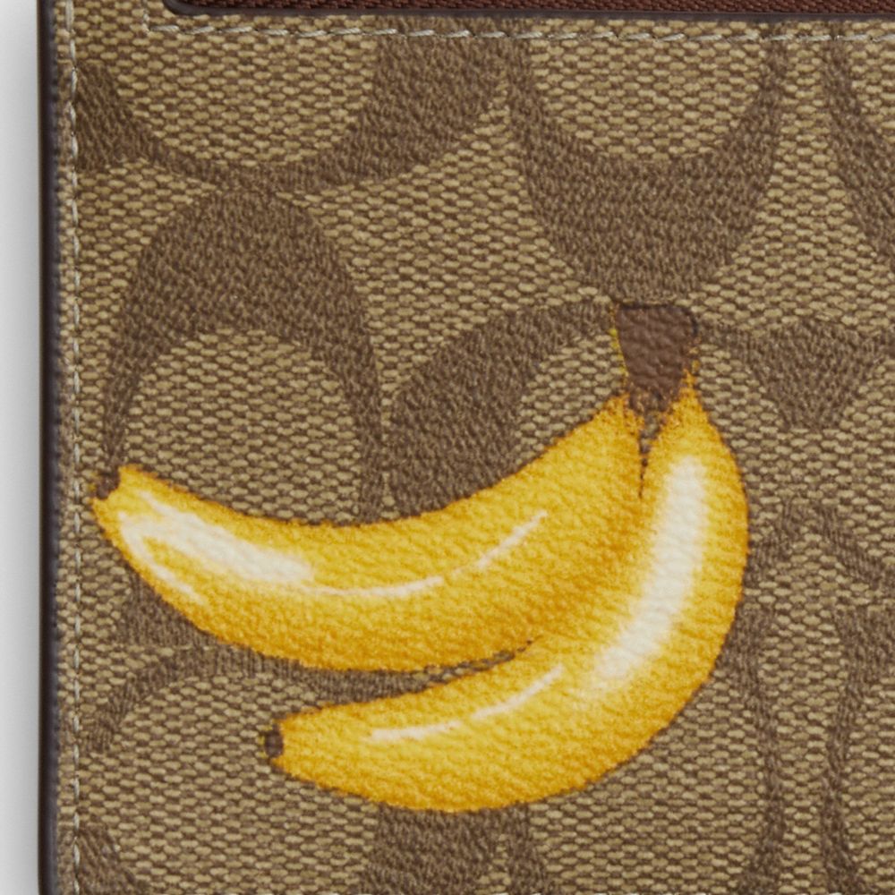 COACH®,ZIP CARD CASE IN SIGNATURE CANVAS WITH BANANA PRINT,Signature Canvas,Mini,Silver/Khaki/Dark Saddle