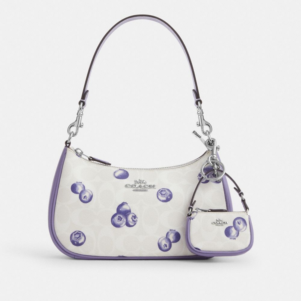COACH®,Mini Nolita Bag Charm In Signature Canvas With Blueberry Print,,Angle View