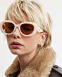 COACH®,PILLOW TABBY ROUND SUNGLASSES,Milky Ivory,Angle View