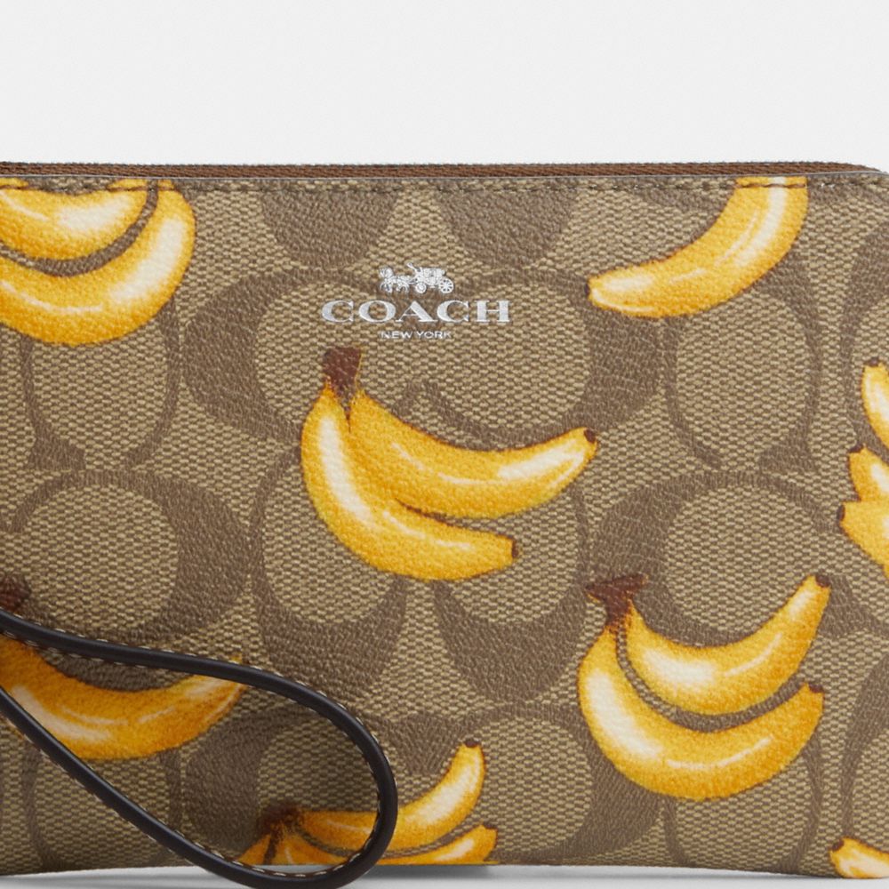 COACH®,CORNER ZIP WRISTLET IN SIGNATURE CANVAS WITH BANANA PRINT,Signature Canvas,Mini,Silver/Khaki/Dark Saddle