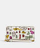 COACH®,LONG ZIP AROUND WALLET WITH CREATURE PRINT,pvc,Mini,Gold/Chalk Multi,Front View