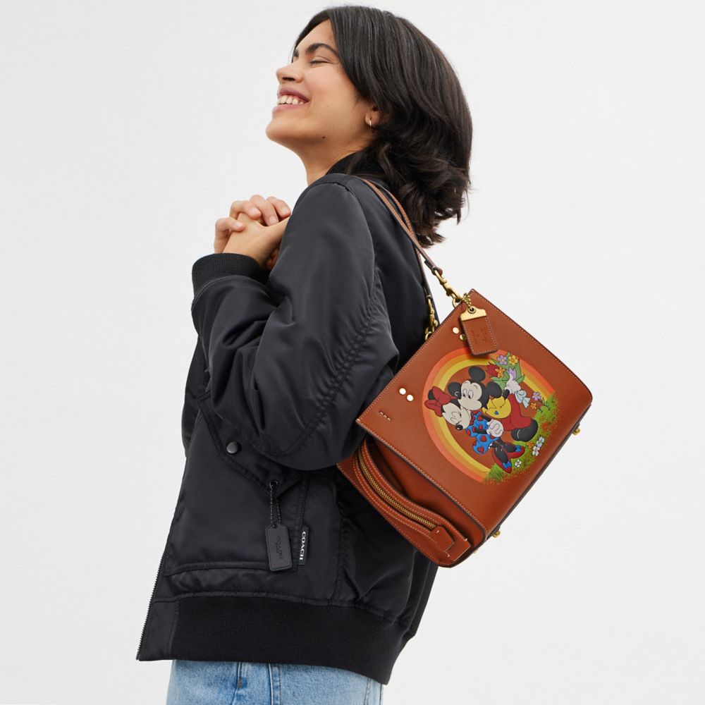 Coach Disney X  Rogue Bag 25 With Mickey Mouse And Minnie Mouse In Brass/burnished Amber Multi