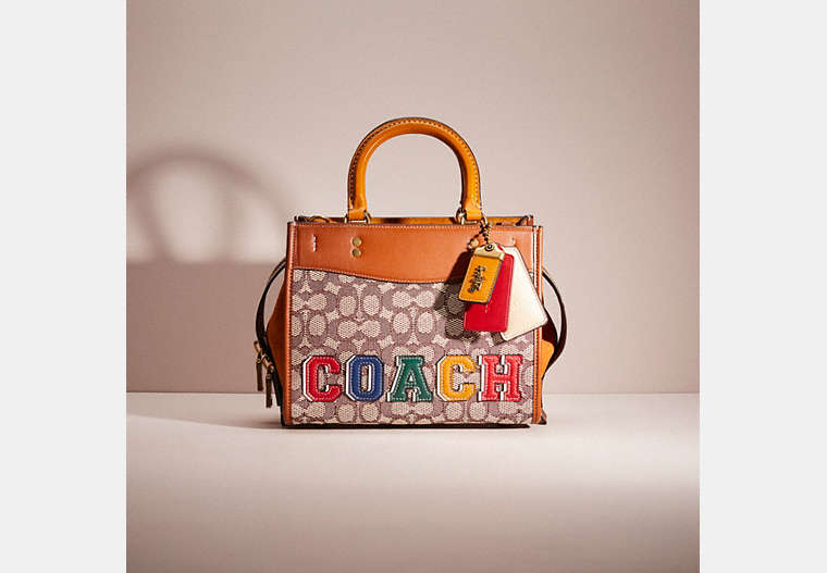 COACH®,UPCRAFTED ROGUE 25 IN SIGNATURE TEXTILE JACQUARD,School Spirit,Brass/Cocoa Burnished Amb,Front View