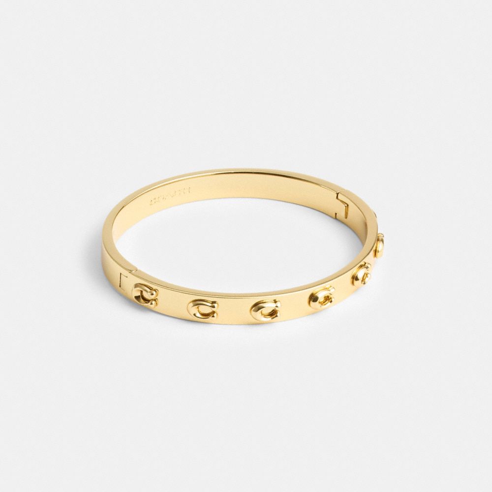 COACH®,PEGGED SIGNATURE HINGED BANGLE,Gold,Front View image number 0