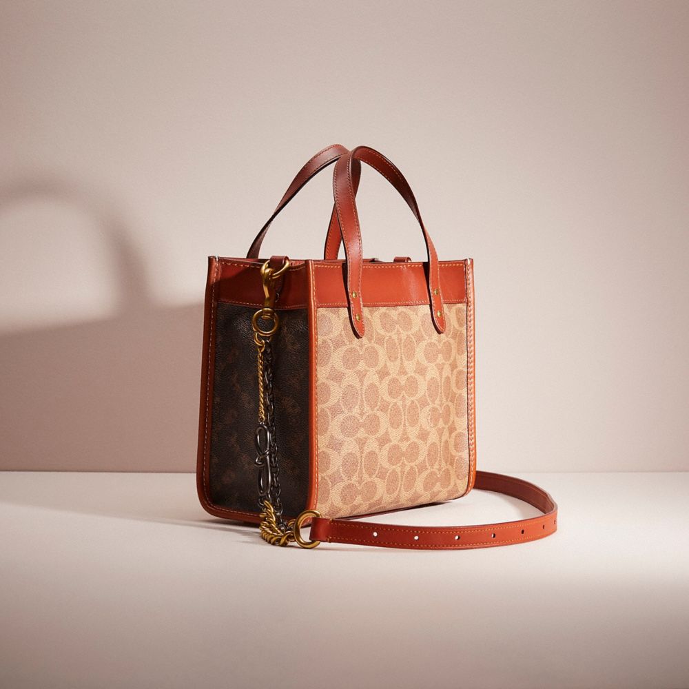 COACH®,UPCRAFTED FIELD TOTE 22 IN SIGNATURE CANVAS WITH HORSE AND CARRIAGE PRINT,Mix-and-Match,Brass/Tan Truffle Rust,Angle View