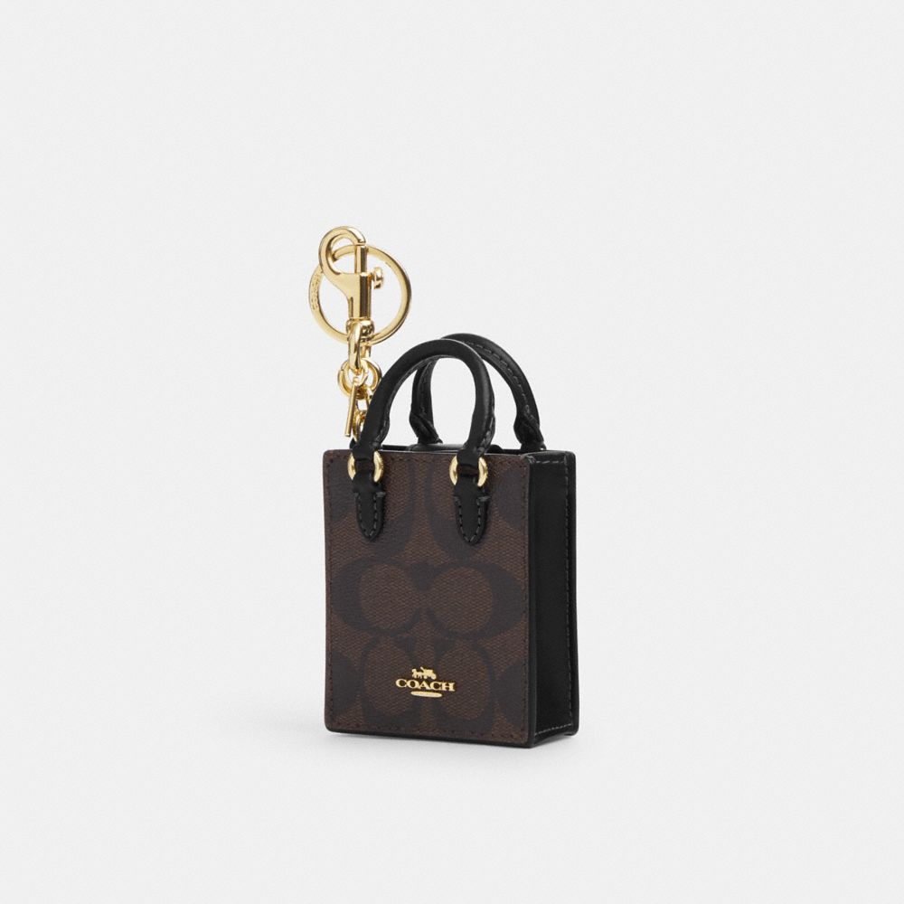 COACH®,NORTH/SOUTH MINI TOTE BAG CHARM IN SIGNATURE CANVAS,Gold/Brown Black,Front View