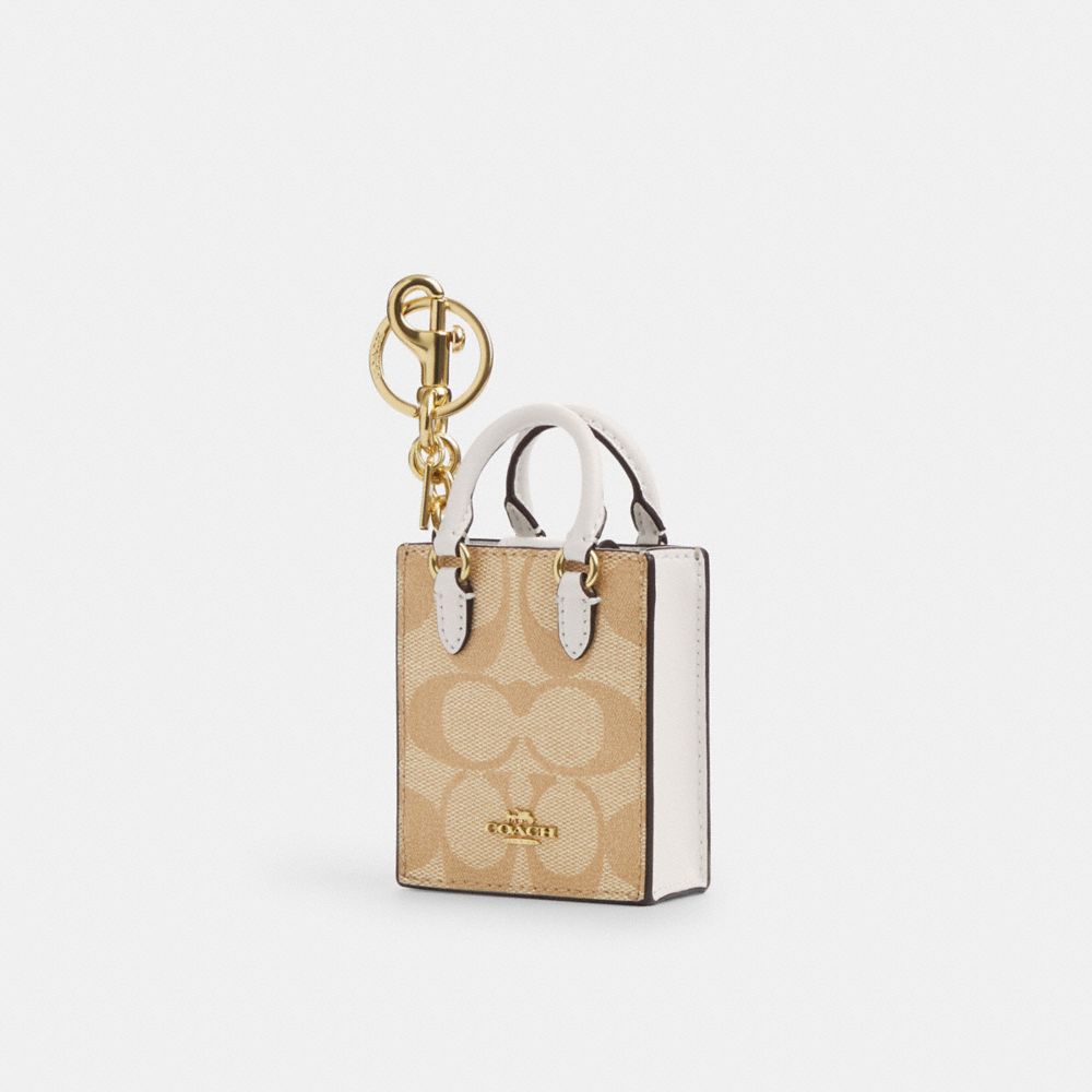 COACH®,NORTH/SOUTH MINI TOTE BAG CHARM IN SIGNATURE CANVAS,Gold/Light Khaki Chalk,Front View