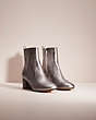 COACH®,RESTORED JULIET ANKLE BOOTIE,Metallic Leather,Gunmetal,Angle View