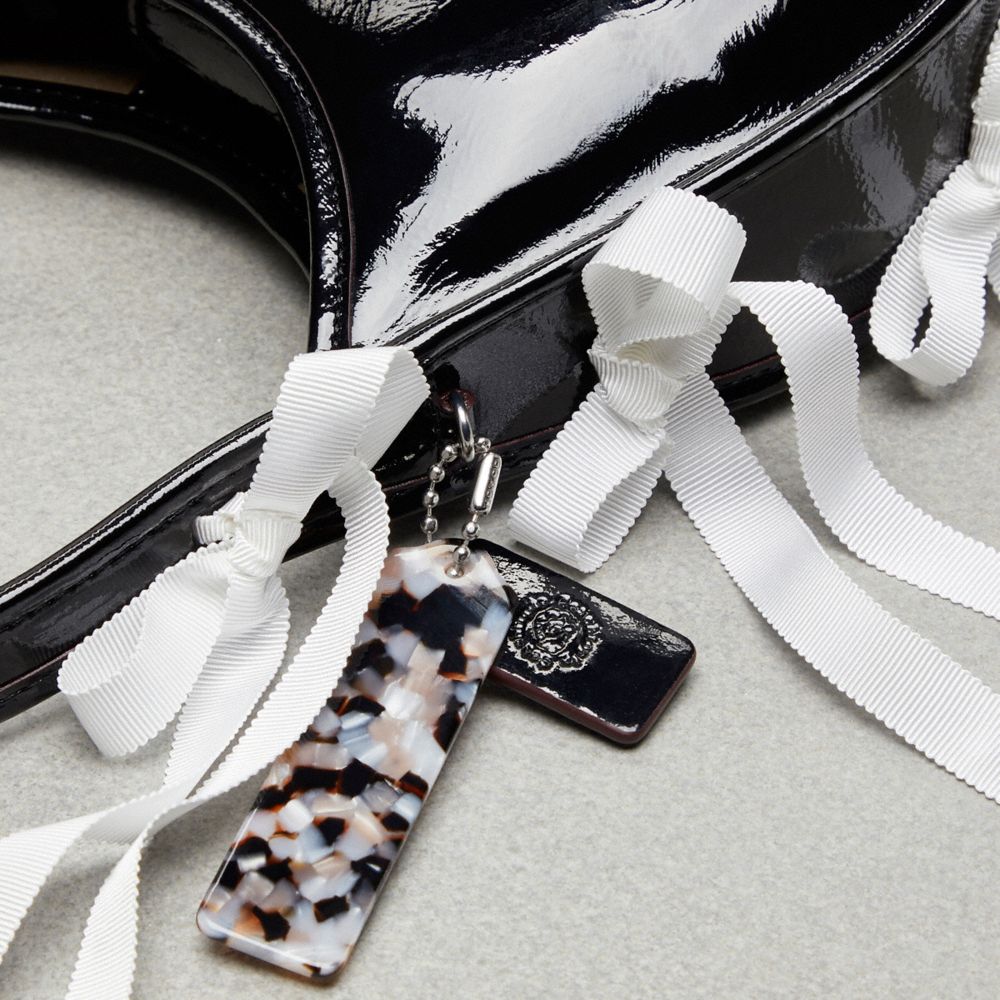 Coach Ergo Bag In Crinkle Patent Topia Leather With Bows All Over In Black