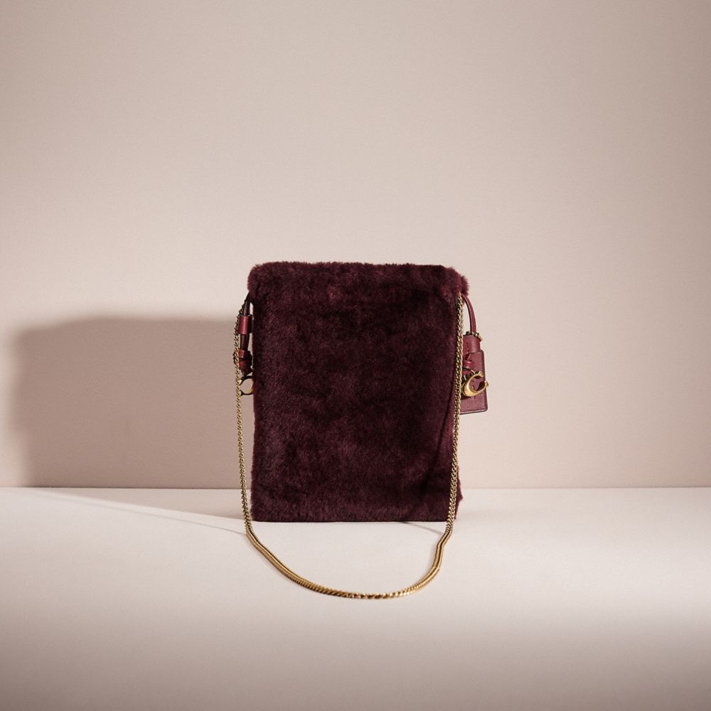 Coach Restored Drawstring Pouch In Shearling In Brass/sangria