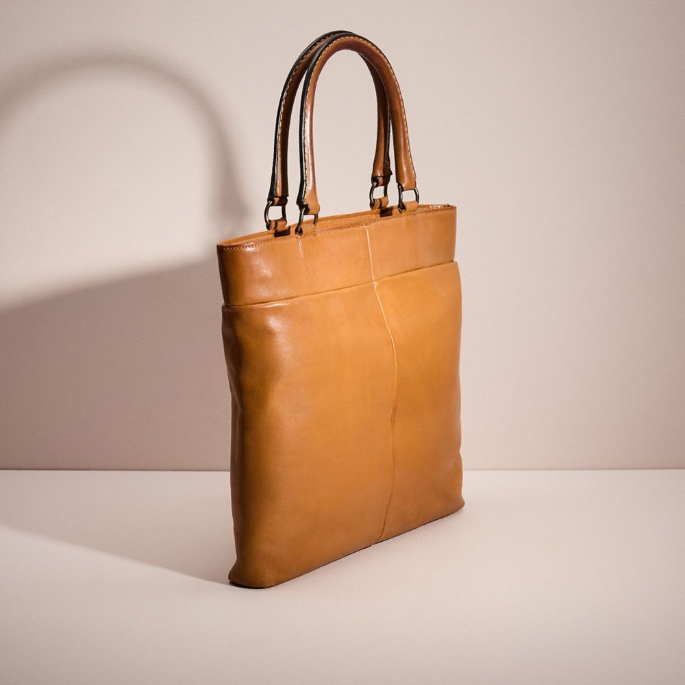 COACH®,VINTAGE CASHIN CARRY SKINNY TOTE,Glovetanned Leather,Medium,Bonnie Cashin Edit,Saddle,Angle View