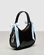 COACH®,Ergo Bag in Crinkle Patent Coachtopia Leather with Bows,Black/Pale Blue,Angle View