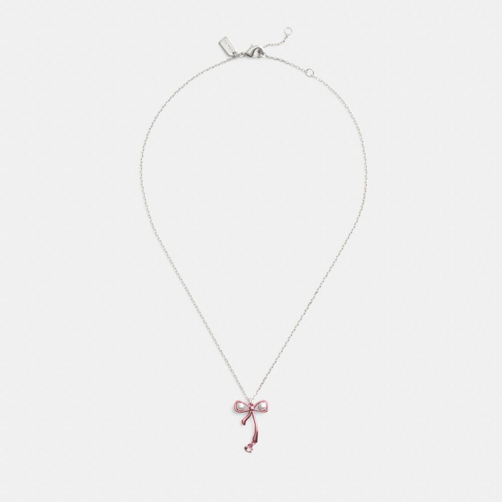 Shop Coach Bow Pearl Pendant Necklace In Silver/pink