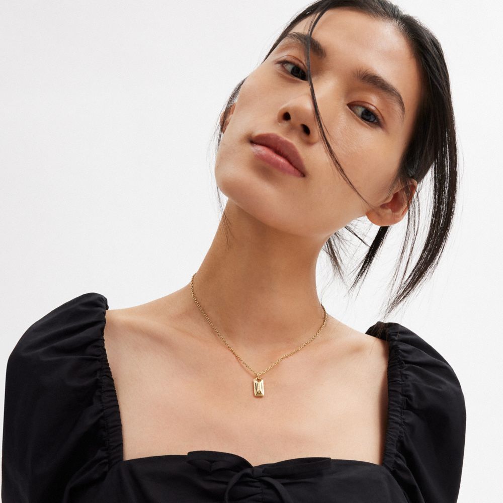 COACH®,Stitched Hangtag Pendant Necklace,Single Strand,Cubic Zirconia,Logo,Casual,,Detail View