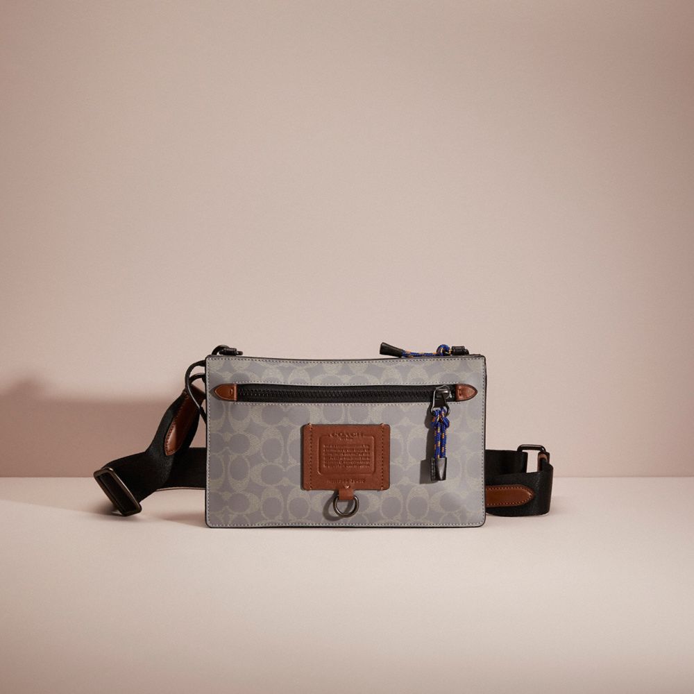 COACH®,RESTORED RIVINGTON CONVERTIBLE POUCH IN REFLECTIVE SIGNATURE CANVAS,Silver/Saddle/Black,Front View