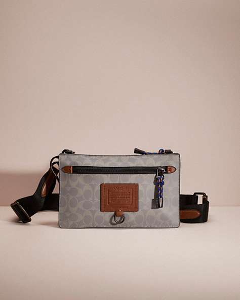 COACH®,RESTORED RIVINGTON CONVERTIBLE POUCH IN REFLECTIVE SIGNATURE CANVAS,Silver/Saddle/Black,Front View