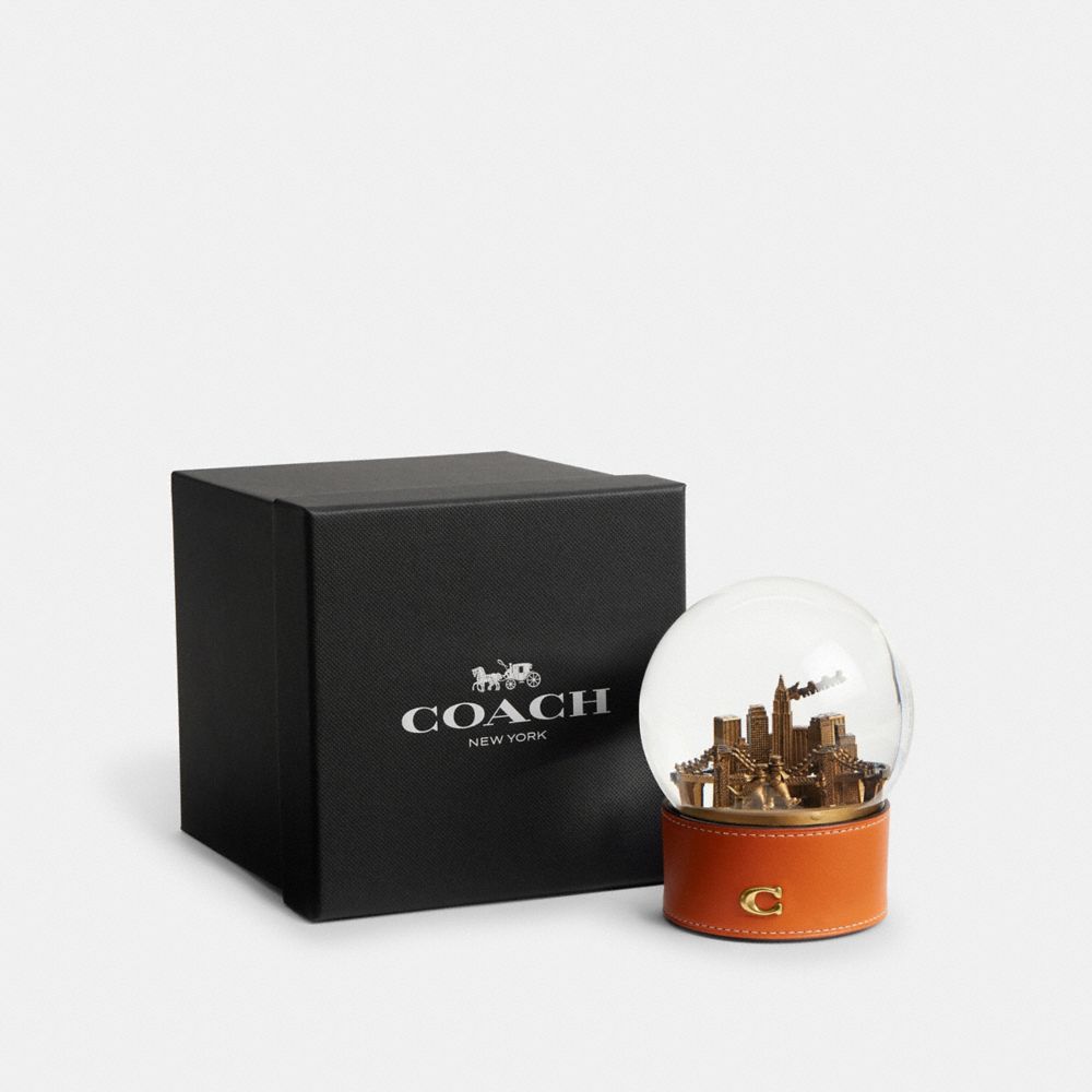 COACH®,Snow Globe With Rexy And Snowman,Snowglobe,Glass,Gold Embellishment,Brass,Brown,Front View