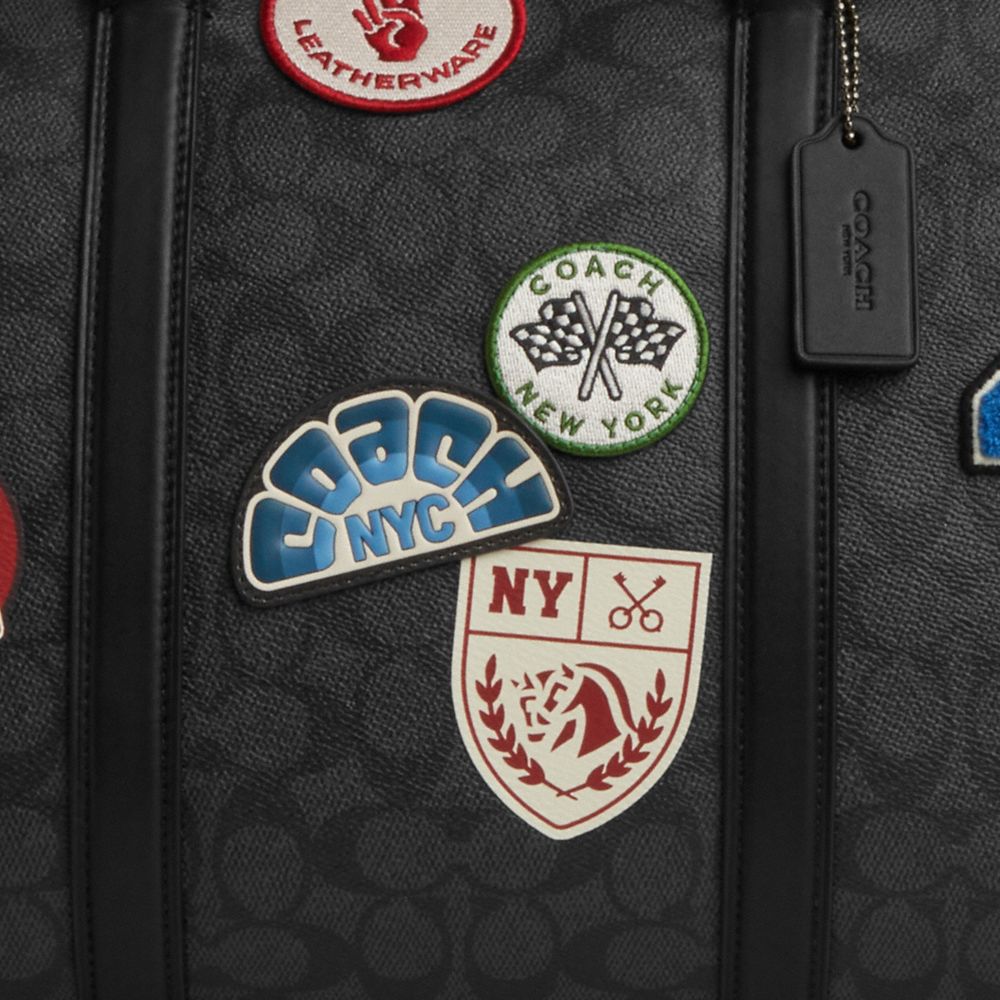 COACH®,Venturer Bag In Signature Canvas With Patches,Canvas,Duffle Bag,Logo,Graphic,Monogram Embellishment,Black