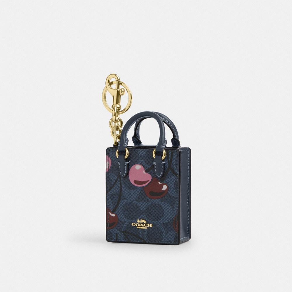 COACH®,North/South Mini Tote Bag Charm In Signature Canvas With Cherry Print,Black,Front View