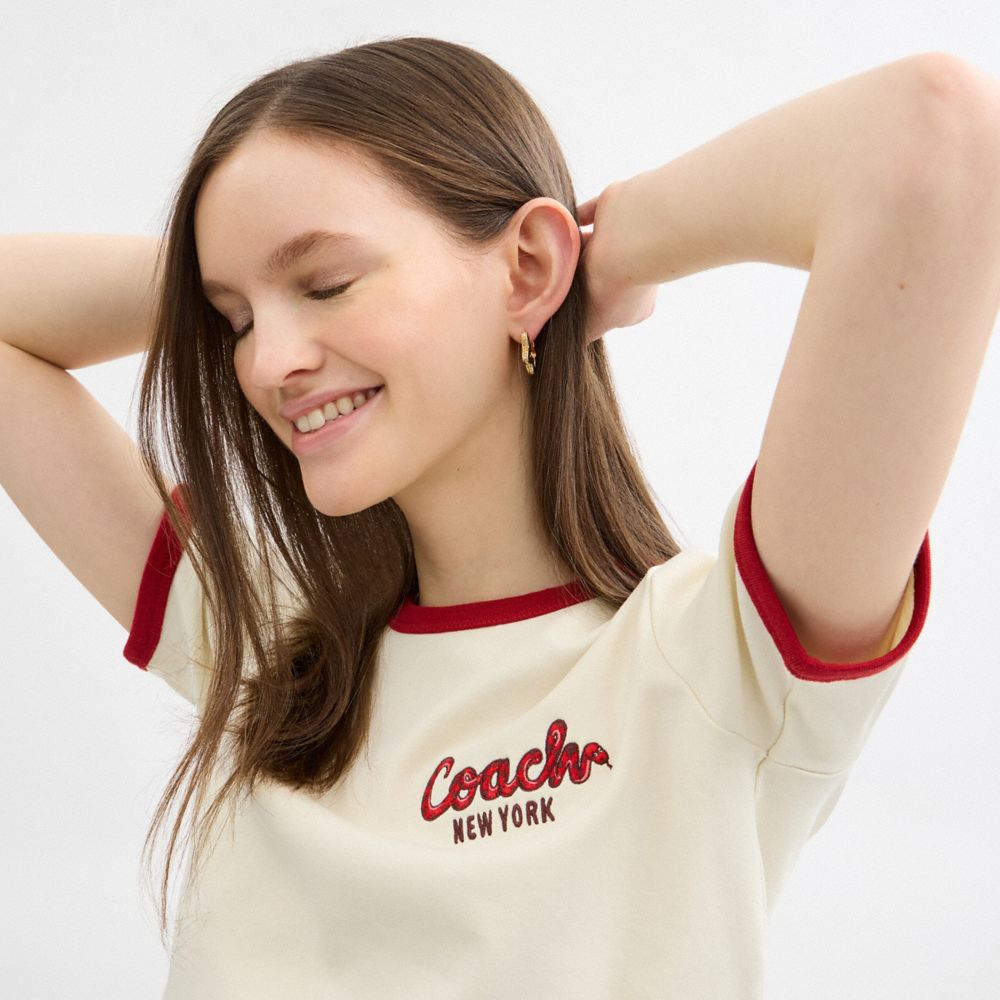 COACH®,New Year Ringer T Shirt In Organic Cotton,Organic Cotton,T Shirt,Logo,Word Embellishment,Piping,Sustainable,Casual,Cream,Detail View