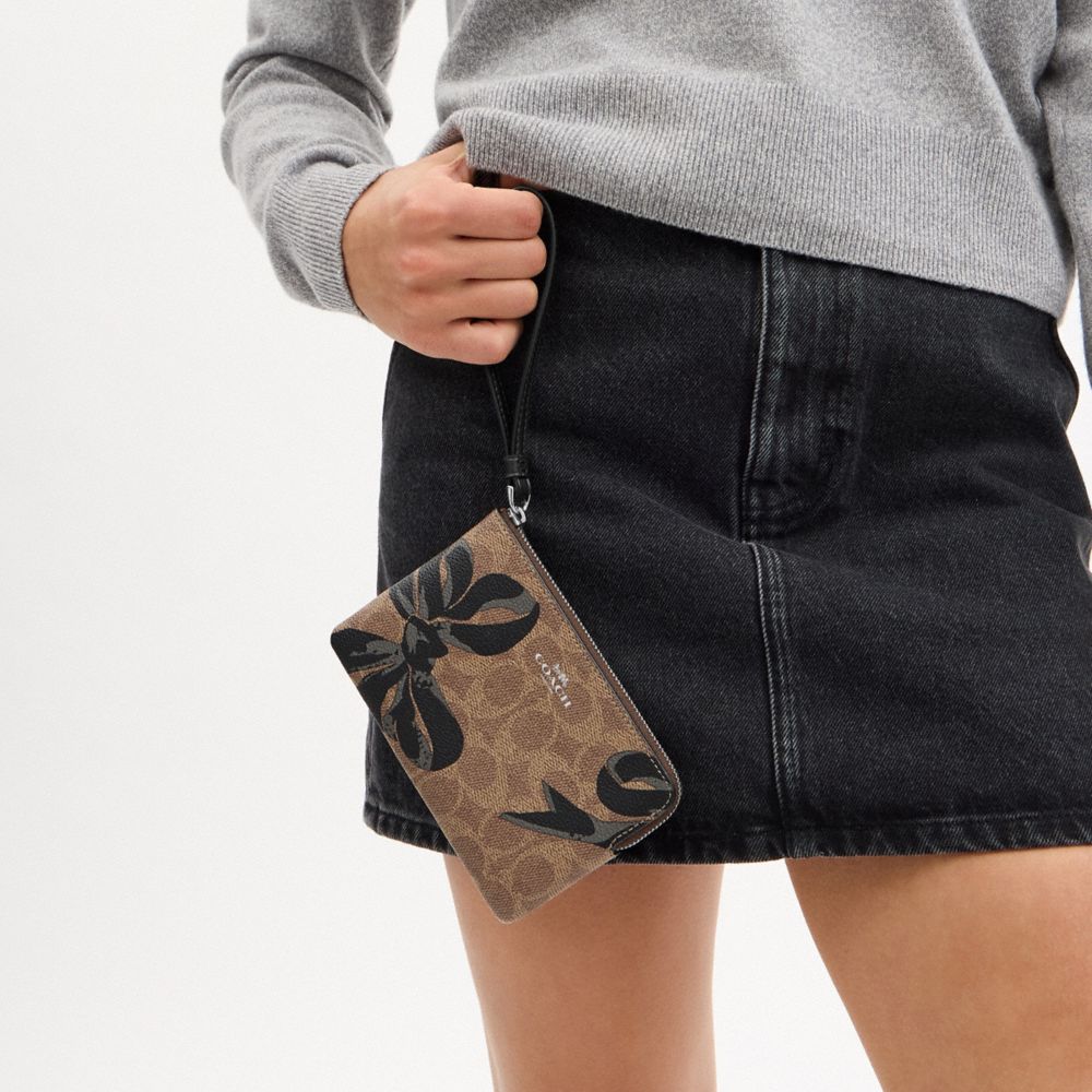 COACH®,Corner Zip Wristlet In Signature Canvas With Bow Print,,Detail View