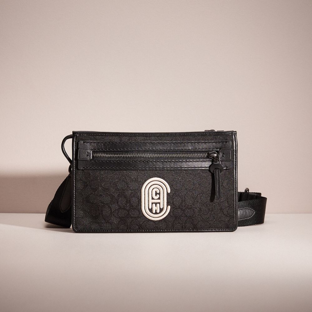 COACH®,RESTORED RIVINGTON CONVERTIBLE POUCH IN SIGNATURE JACQUARD WITH COACH PATCH,Black/Chalk,Front View