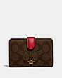 COACH®,MEDIUM CORNER ZIP WALLET IN SIGNATURE CANVAS,Gold/Brown Ruby,Front View