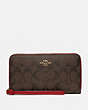 COACH®,LARGE PHONE WALLET IN SIGNATURE CANVAS,Gold/Brown True Red,Front View