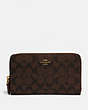 COACH®,CONTINENTAL ZIP AROUND WALLET IN SIGNATURE CANVAS,Gold/Brown Black,Front View