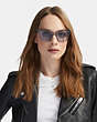 COACH®,HORSE AND CARRIAGE HOLOGRAM SQUARE SUNGLASSES,Mixed Material,Grey Trans/Violet Lens,Angle View