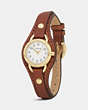 COACH®,DREE GOLD PLATED LEATHER BUCKLE CUFF WATCH,Leather,Saddle,Angle View